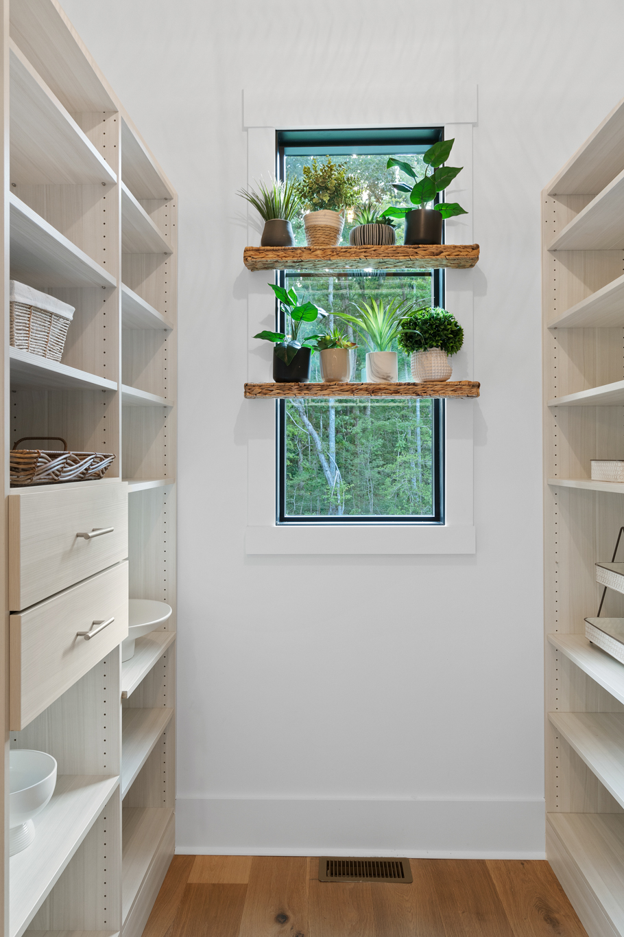 Walk-in pantry with white built-in shelving and drawers
