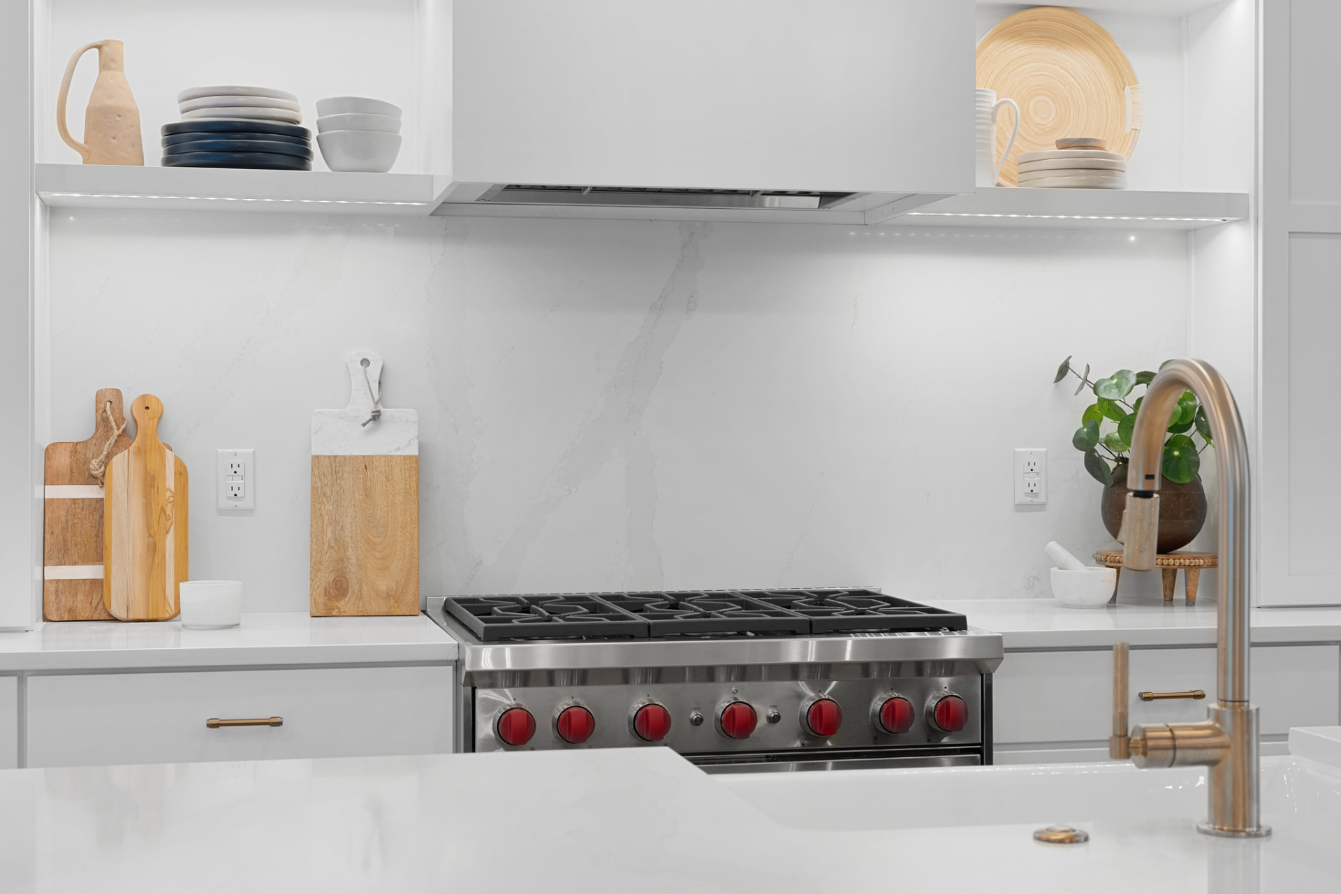 Kitchen range wall with white cabinetry and open shelves