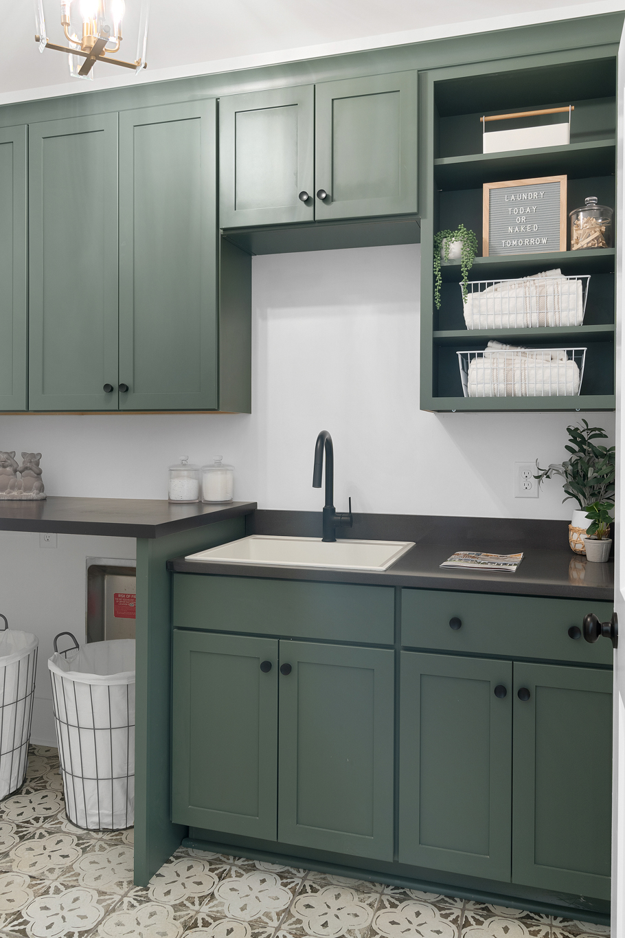 Laundry room with green shaker cabinetry and open shelving