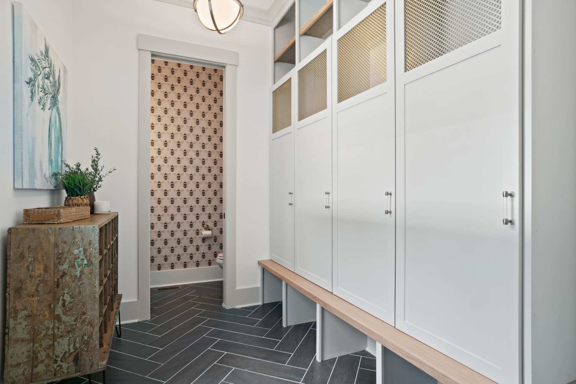 Mudroom with white lockers and built-in bench